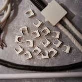 Крепеж-клипса Rexant для труб под монтажный пистолет в п/э d25 [упак.50шт] серая