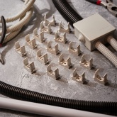 Крепеж-клипса Rexant для труб под монтажный пистолет в п/э d25 [упак.50шт] серая