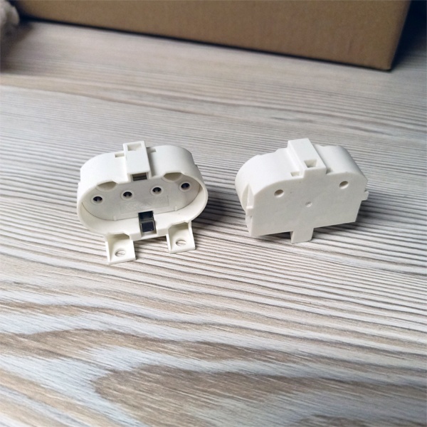 Патрон 2G11 с торцевым и боковым креплением под патроны М3 и М4 для компактных люминесцентных ламп.