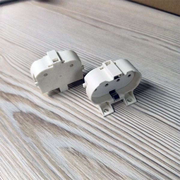 Патрон 2G11 с торцевым и боковым креплением под патроны М3 и М4 для компактных люминесцентных ламп.